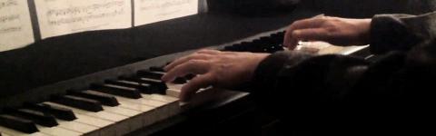 A man's hands playing the piano